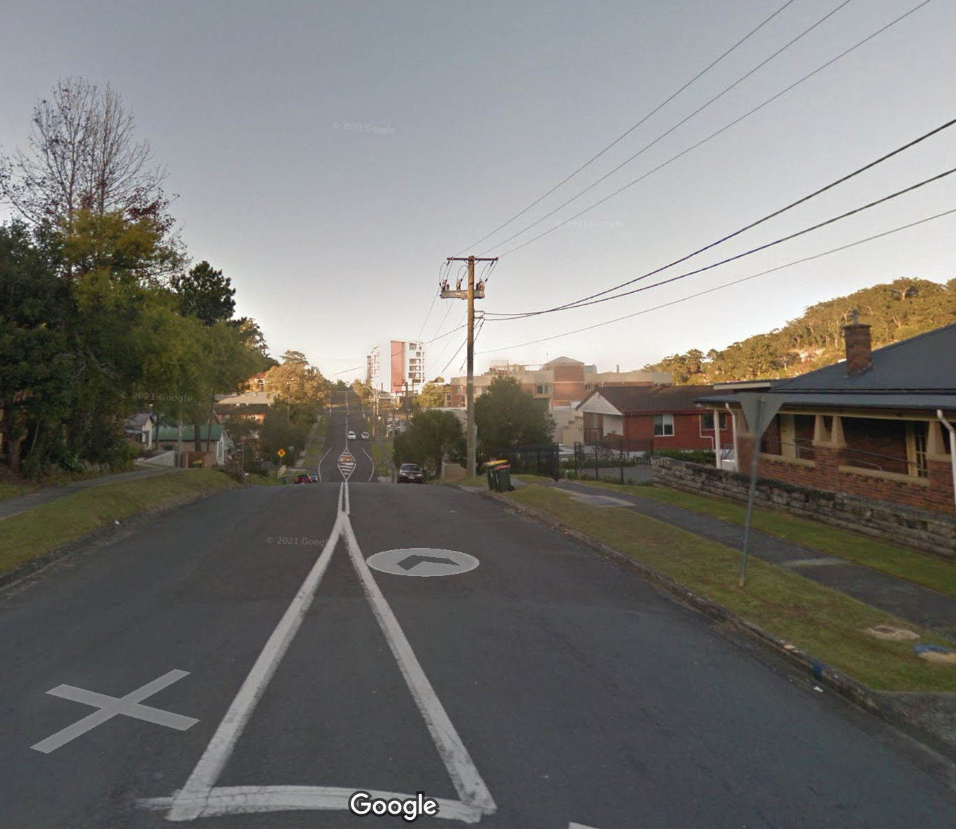 Screenshot of Google StreetView from the top of a hill at dusk