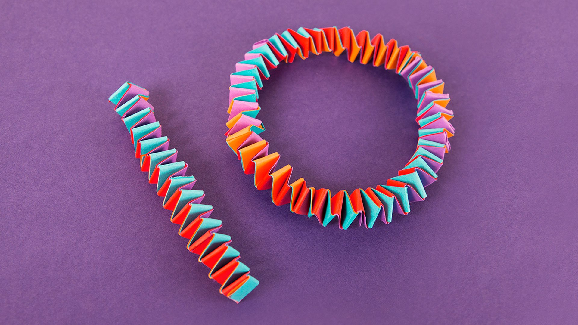 Graphic render of the number 10 made out of multicoloured paper folded concertina style